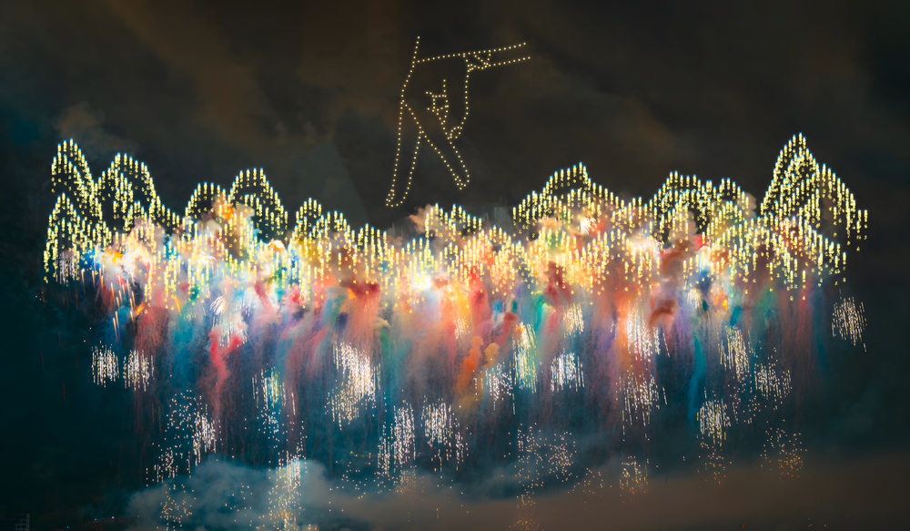 Drone light show spelling out a proposal above a crowd